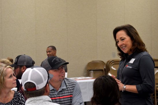 Entergy Texas President and CEO Sallie Rainer takes time during ceremony to meet with families of graduates.